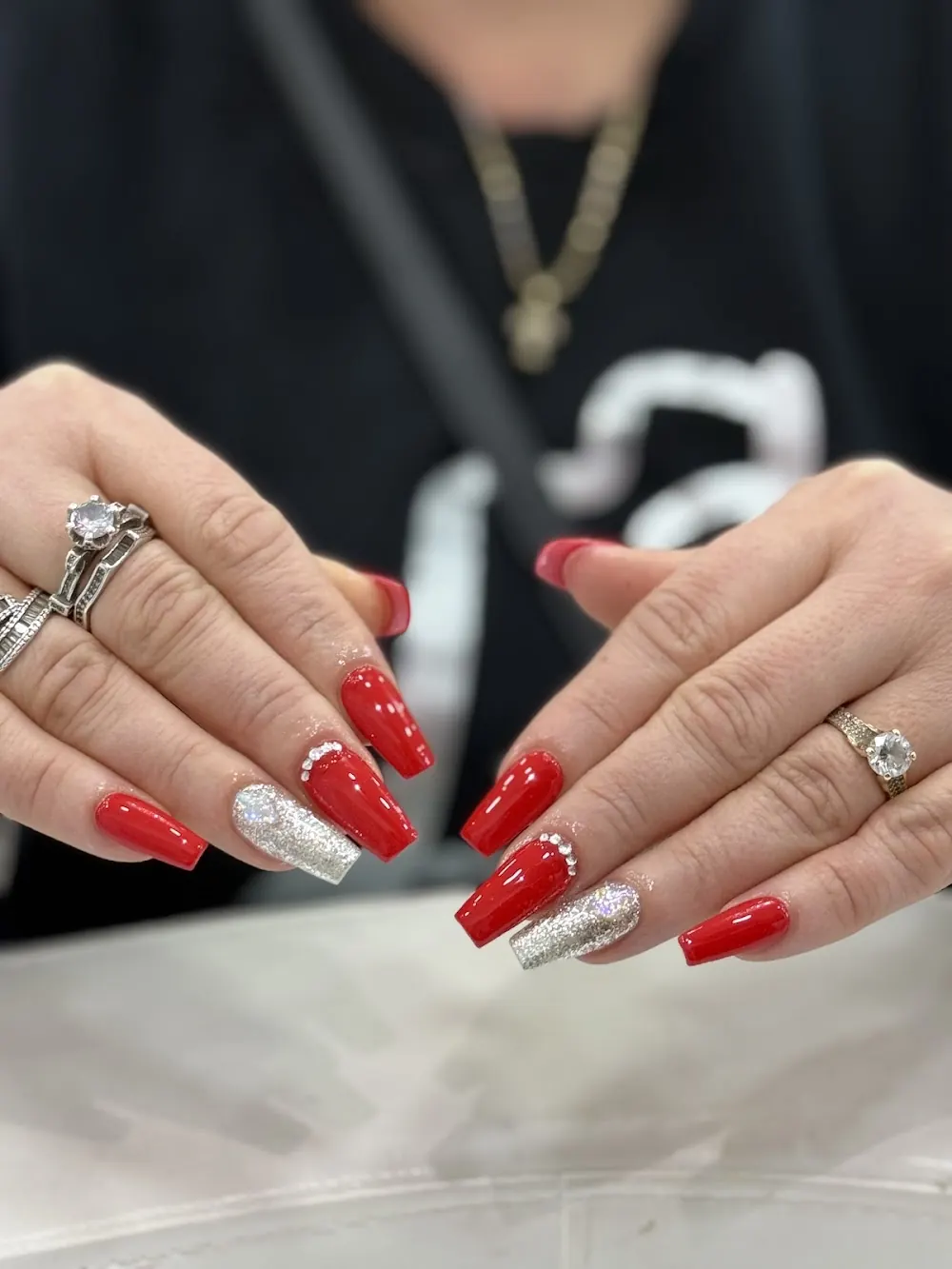 Red nails with white tips and silver detail