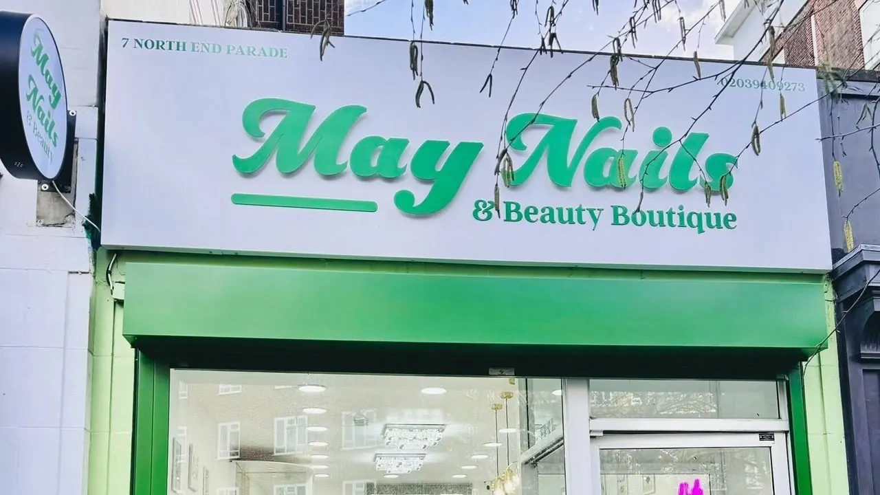 The green May Nails shop sign on North End Parade